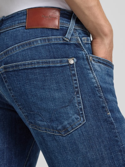 Männermodel trägt Slim Fit Jeans aus Baumwoll-Mix Modell 'HATCH' von Pepe Jeans in dunklem Denim mit Kontrastnähten, Nahaufnahme Rückansicht.