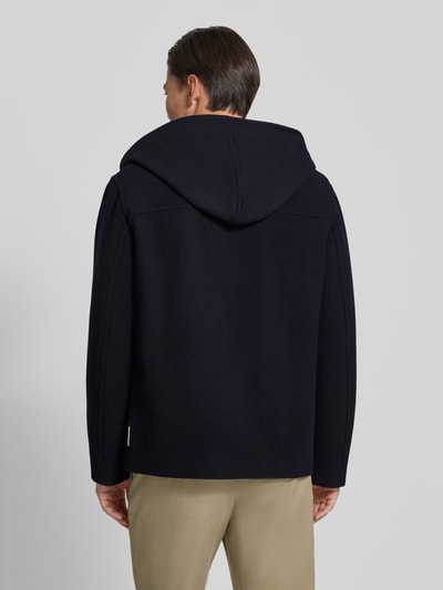 Mężczyznamodel nosi Regular Fit Jacke aus Schurwoll-Mix od Armani Exchange, głęboki granat, kaptur, wpuszczane kieszenie, długość tyłu 74 cm, szerokość ramion w rozmiarze M: 50 cm, szerokość klatki piersiowej w rozmiarze M: 61 cm, długość rękawów: 66 cm, widok całej sylwetki od tyłu.