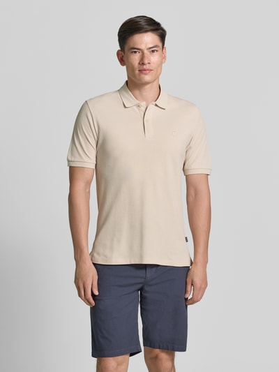 Męski model nosi Slim Fit Poloshirt mit Stitching von Jack & Jones Premium z bawełny, krój slim fit, haft, listwa guzikowa, długość tyłu w rozmiarze M: 70 cm, widok całej sylwetki z przodu.