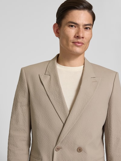 Männermodel trägt Slim Fit Anzugsakko aus Baumwoll-Mix Modell 'HENRY' von HUGO, Optik: Unifarben, Nahaufnahme Oberkörper.