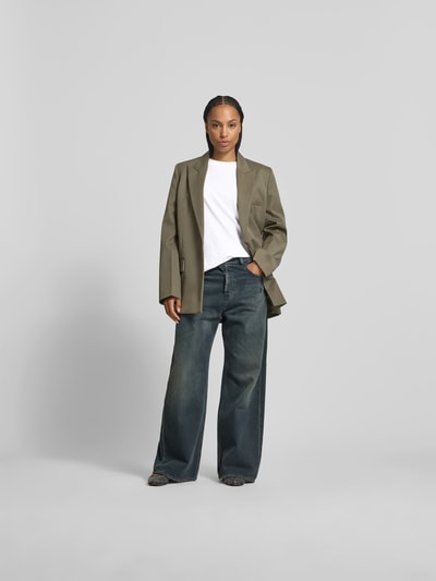 Frauenmodel trägt Oversized T-Shirt mit Label-Stitching von black palms aus reiner Baumwolle, Rundhalsausschnitt, Weiß, Ganzkörperansicht von vorne.