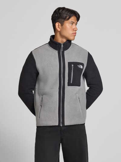 Männermodel trägt The North Face Fleecejacke mit Stehkragen Modell 'YUMIORI', grau-schwarz, lockere Passform, Ganzkörperansicht von vorne.
