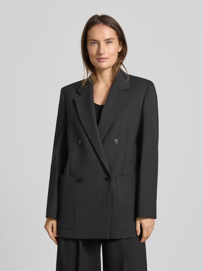 Frauenmodel trägt Loose Fit Longblazer mit Schurwoll-Anteil Modell 'VELOCE' von Weekend Max Mara, Optik: Unifarben, 2-Knopf-Verschluss, Reverskragen, Label-Stitching-Applikation, aufgesetzte Seitentasche, Ganzkörperansicht von vorne.