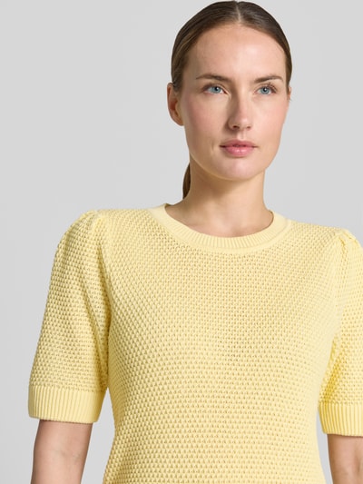 Vrouwenmodel draagt Slim Fit T-shirt in tricotlook model 'Vidalo' van Vila, puur katoen, ronde hals, zachte gele kleur, textuurstructuur, Nahaufnahme bovenlichaam.