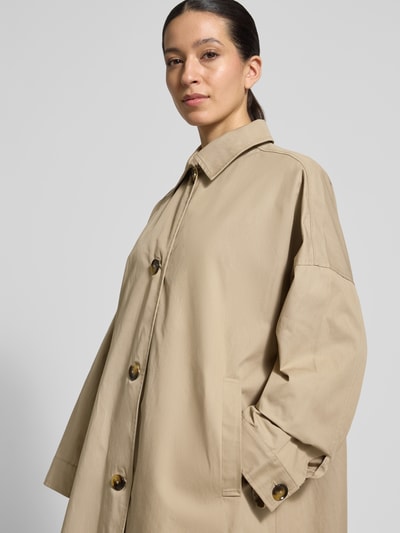 Frauenmodel trägt Regular Fit Mantel mit Umlegekragen Modell 'Zofia' von FREE/QUENT in Beige, Baumwoll-Mix, Knopfleiste, Eingrifftaschen, Nahaufnahme Oberkörper.