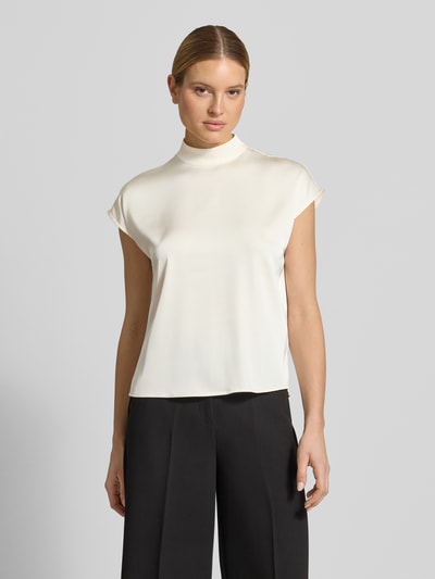 Frauenmodel trägt Blusenshirt mit Stehkragen von Jake*s Collection aus Material-Mix mit Stretch-Anteil, Regular-Fit, Rückenreißverschluss, Farbe Creme, glatte Textur, Ganzkörperansicht von vorne.