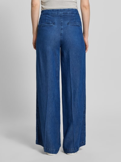 Frauenmodel trägt Wide Leg Jeans mit Zierknöpfen und französischen Eingrifftaschen von Rich & Royal, Baumwoll-Mix, ausgestellter Schnitt, Bügelfalte, Haken-Reißverschluss, Gesäßleistentaschen, Ganzkörperansicht Rückansicht.