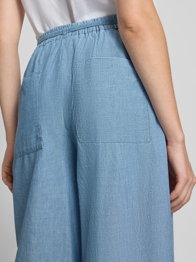 Vrouwenmodel draagt Wide Fit broek met bandplooien in denimlook van Stefanel, puur katoen, elastische band met tunnelkoord, detailopname rug.