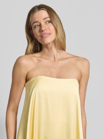 Frauenmodel trägt Abendkleid mit Bandeau-Ausschnitt von Swing aus Material-Mix mit Stretch-Anteil in Gelb, Nahaufnahme Oberkörper.