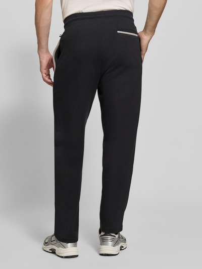 Männermodel trägt Regular Fit Sweatpants aus Baumwoll-Mix Modell 'Sense Pants' von BOSS, dunkle Farbe, glatte Textur, Ganzkörperansicht Rückansicht. Herren Sweatpants von BOSS.