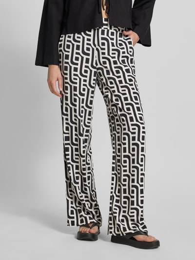 Vrouwenmodel draagt Wide Leg Pants uit viscose met steekzakken van Christian Berg Woman, zwart-wit, los model, elastische band, zuiver viscose, binnenbeenlengte maat 36: 77 cm, bandwijdte maat 36: 38 cm, voorkant opname, detailopname onderlichaam.
