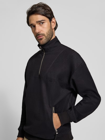 Męski model nosi Regular Fit Troyer aus Baumwoll-Mix mit Woll-Anteil Modell 'Deren' von HUGO, czarny, gładka faktura, widok z przodu, zbliżenie górnej części ciała.