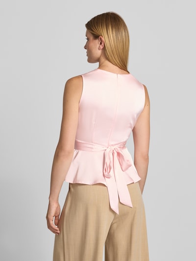 Frauenmodel trägt Blusentop in Wickel-Optik Modell 'Risetta' von Neo Noir in Rosa, Material-Mix mit Stretch, Ganzkörperansicht Rückansicht.