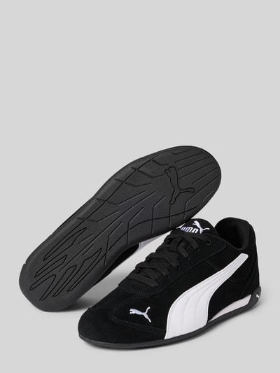Produktfoto, Sneaker aus Leder-Mix Modell 'Replicatch' von PUMA, schwarz mit weißem Logo-Stitching, glatte Sohle, abgerundete Passform