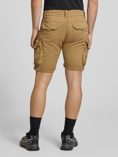 Männermodel trägt Shorts mit Cargotaschen Modell 'CREW SHORT' von Alpha Industries im Regular-Fit aus Baumwoll-Elasthan-Mix, sandfarben, Ganzkörperansicht Rückansicht, Bundweite bei Größe 32: 44 cm, Innenbeinlänge bei Größe 32: 22 cm.