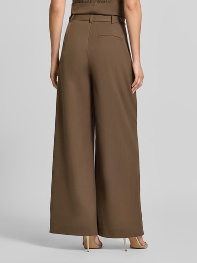Vrouwenmodel draagt Wide Fit broek met viscosemix model 'Stacy' van Gestuz in bruin met bandplooien, bandwijdte maat 36: 38 cm, binnenbeenlengte maat 36: 81 cm, elastische materiaalmix, knoop- en ritssluiting, geheel van achteren.