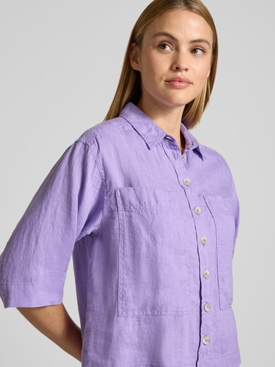 Frauenmodel trägt Regular Fit Leinenbluse mit Brusttaschen von Emily Van den Bergh in Flieder, reine Leinenstruktur, Nahaufnahme Oberkörper.