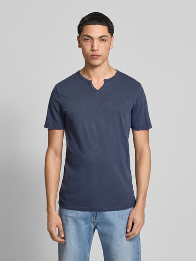 Männermodel trägt T-Shirt aus Baumwolle Modell 'SPLIT' von Jack & Jones in Dunkelblau, gerader Schnitt, V-Ausschnitt, Knopfverschluss, Ganzkörperansicht von vorne.