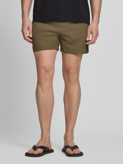 Männermodel trägt Relaxed Fit Badeshorts mit Logo-Stitching von Emporio Armani in Oliv mit elastischem Bund und Tunnelzug, Ganzkörperansicht von vorne.
