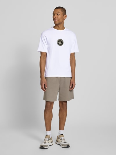 Männermodel trägt Regular Fit T-Shirt aus reiner Baumwolle Modell 'DOBUL' von HUGO in Weiß, fein gerippt, Rundhals, unifarben, Label Stitching, Ganzkörperansicht von vorne.