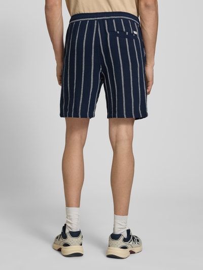 Männermodel trägt Regular Fit Shorts mit Tunnelzug von Jack & Jones in Dunkelblau mit weißen Streifen, Gesäßtasche, Reine Baumwolle, Ganzkörperansicht Rückansicht.