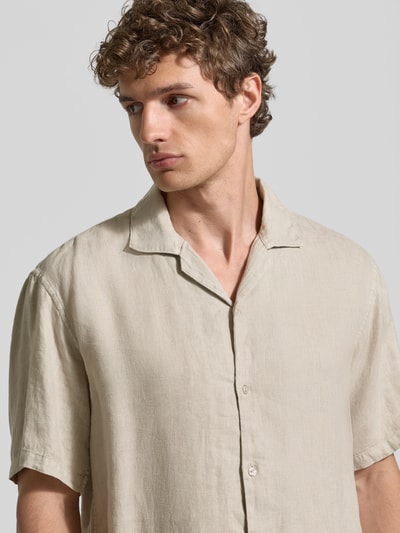 Männermodel trägt Regular Fit Leinenhemd mit Reverskragen von MCNEAL in Beige, reine Leinen-Qualität, Knopfleiste, Kurzärmelig, Nahaufnahme Oberkörper.
