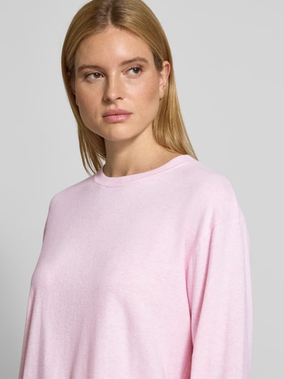 Frauenmodel trägt Longsleeve mit geripptem Rundhalsausschnitt von American Vintage in Hellrosa, lockerer Schnitt, Baumwoll-Modal-Mix, Nahaufnahme Oberkörper.