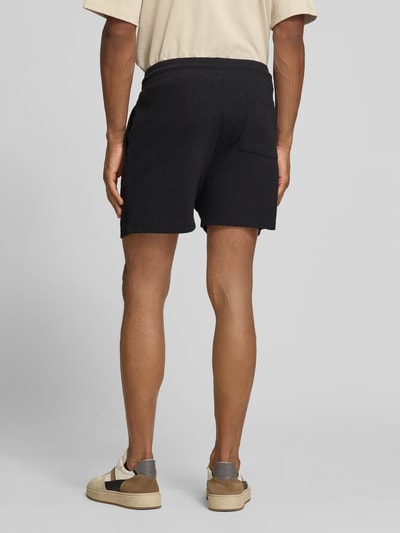 Männermodel trägt Regular Fit Shorts aus Baumwoll-Mix Modell 'FILIP' von Strellson in Schwarz mit Seitentaschen, Rückenansicht, Ganzkörperansicht Rückansicht.