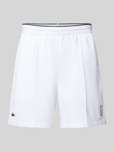 Produktfoto, Regular Fit Sport-Shorts mit elastischem Bund von Lacoste Sport in Weiß mit Logo-Patch, Kontraststreifen, Tunnelzug, seitlichen Taschen