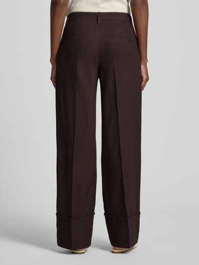 Frauenmodel trägt Hose aus Leinen-Viskose-Mix Modell 'Ottavie' von mbyM, dunkelbraun, Wide Leg, Bügelfalten, Ganzkörperansicht Rückansicht, Damen Hose, Bundweite 39 cm, Innenbeinlänge 81 cm bei Größe S.