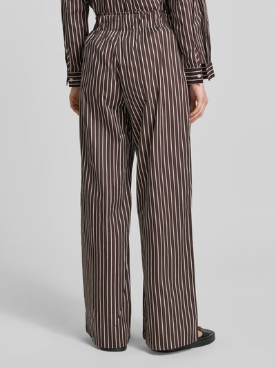 Frauenmodel trägt Weite Damen Hose aus reiner Baumwolle Modell 'MAVIE' von VILLA SOPHIE, Optik:Allover-Muster, Regular-Fit, High-Waist, Label-Patch, elastischer Bundabschluss, seitliche Eingrifftaschen, Material: Reine Baumwolle, Ganzkörperansicht Rückansicht.