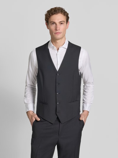 Männermodel trägt Weste mit V-Ausschnitt und Paspeltaschen Modell 'Tobias' von Carl Gross, reine Schurwolle, Slim Fit, Ganzkörperansicht von vorne.