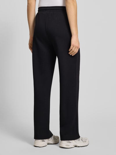 Frauenmodel trägt Regular Fit Sweatpants mit Viskose-Anteil Modell 'TALIA' von Pieces in Schwarz, Sweat-Material, Ganzkörperansicht Rückansicht.