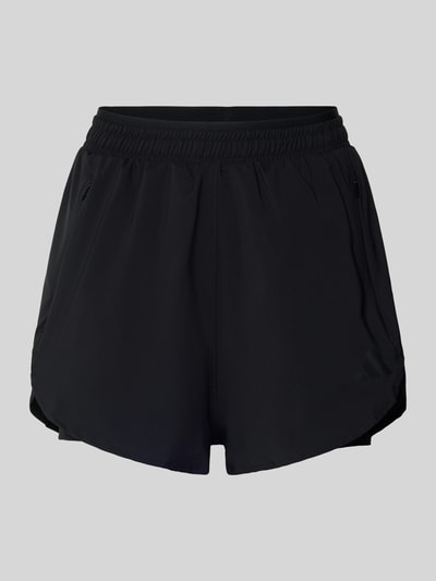 Produktfoto, schwarze Regular Fit Shorts mit Reißverschlusstaschen von adidas Sportswear, elastischer Bund, 2-in-1-Look, glatte Textur.