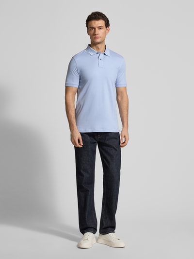 Männermodel trägt Regular Fit Poloshirt mit Logo-Stitching von Fynch-Hatton, hellblau, reine Baumwolle, Polokragen, Ganzkörperansicht von vorne.