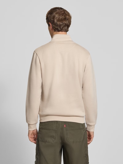 Männermodel trägt Regular Fit Sweatjacke mit Baumwoll-Anteil Modell 'Bradley' von JACK & JONES in Beige, glatte Oberfläche, Ganzkörperansicht Rückansicht. Kontext: Herren Sweatjacke, Material-Mix mit Baumwoll-Anteil, Stehkragen, Reißverschluss, geteilte Känguru-Tasche, Rückenlänge bei Größe M 68 cm, Ärmellänge 66 cm.