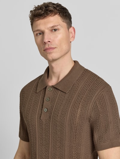 Männermodel trägt Slim Fit Poloshirt mit Knopfleiste von Jack & Jones Premium, Baumwoll-Mix, braun, Strukturstrick, Nahaufnahme Oberkörper. Rückenlänge bei Größe M: 72 cm.