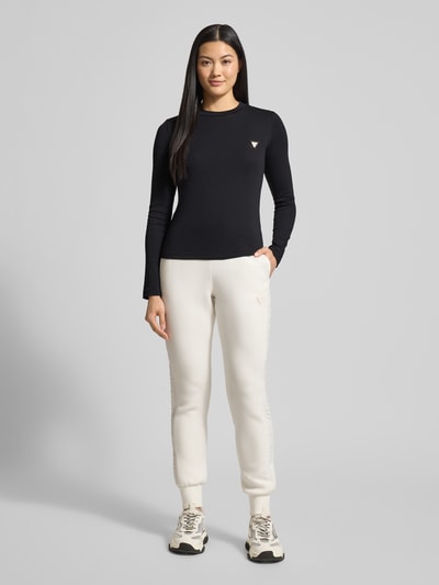 Frauenmodel trägt Longsleeve mit Label-Detail Modell 'SONIA' von Guess Activewear in Schwarz, Baumwolle, Regular Fit, Ganzkörperansicht von vorne.