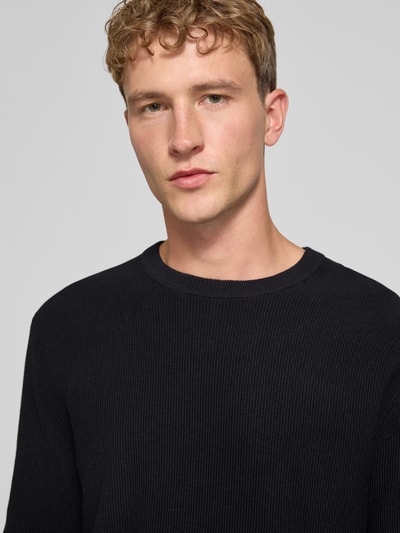 Männermodel trägt Regular Fit Pullover aus reiner Baumwolle Modell 'TONY' von ONLY in Schwarz, strukturierte Oberfläche, Nahaufnahme Oberkörper, Herren Pullover von ONLY & SONS.