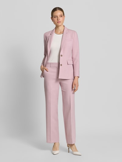 Frauenmodel trägt Regular Fit Weite Hose mit Viskose-Anteil Modell 'RITA' von Selected Femme, melierte Optik in Hellrosa, Webware, seitliche Eingrifftaschen, Gürtelschlaufen, Schiebehaken, Ganzkörperansicht von vorne.