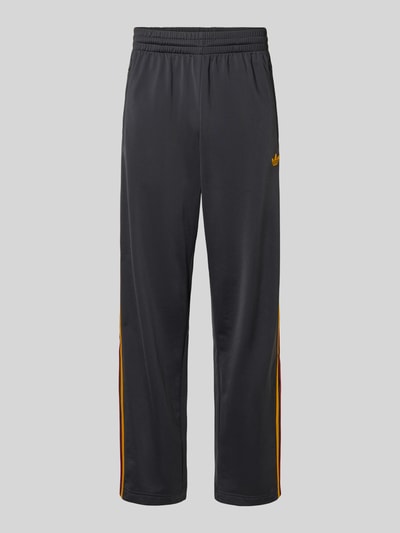 Produktfoto, Relaxed Fit Sweatpants mit Label-Streifen Modell 'FIREBIRD' von adidas Originals, efekt: jednolity kolor, krój relaxed fit, detal z logo, paski z logo, elastyczny ściągacz, tunel, zakończenie nogawek: zamek błyskawiczny, boczne kieszenie zapinane na zamek błyskawiczny, wykończenie materiału: dzianina dresowa