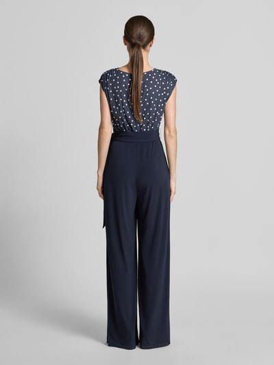 Vrouwenmodel draagt Regular Fit Jumpsuit met V-hals van Vera Mont, donkerblauw, elastische materiaalmix, met plooien en tailleband, mouwloos design, ruglengte maat 36: 39 cm, borstwijdte maat 36: 44 cm, mouwlengte maat 36: 18 cm, totale lengte maat 36: 160 cm, binnenbeenlengte maat 36: 93 cm, geheel van achteren