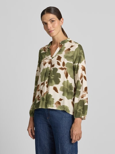 Frauenmodel trägt Relaxed Fit Bluse aus reiner Viskose Modell 'Lari' von ZABAIONE mit Serafino-Ausschnitt, grün-braun gemustert, Langarm, Ganzkörperansicht von vorne.
