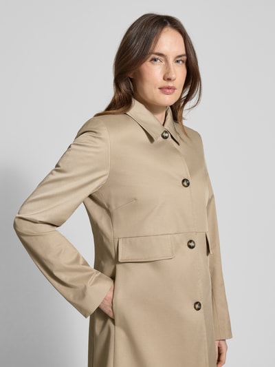 Frauenmodel trägt Regular Fit Mantel mit Umlegekragen Modell 'Mina' von CINQUE, elastischer Baumwoll-Mix, beiges Material, Pattentaschen, durchgehende Knopfleiste, Nahaufnahme Oberkörper.