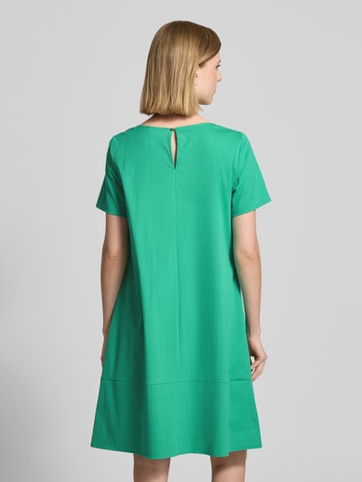 Frauenmodel trägt Minikleid mit rückseitigem Knopfverschluss von ROBE LÉGÈRE aus grünem Baumwoll-Mix mit Stretch-Anteil, A-Linie, Rundhalsausschnitt, Rückansicht, Ganzkörperansicht. Rückenlänge bei Größe 36: 90 cm, Brustweite: 48 cm, Ärmellänge: 22 cm.