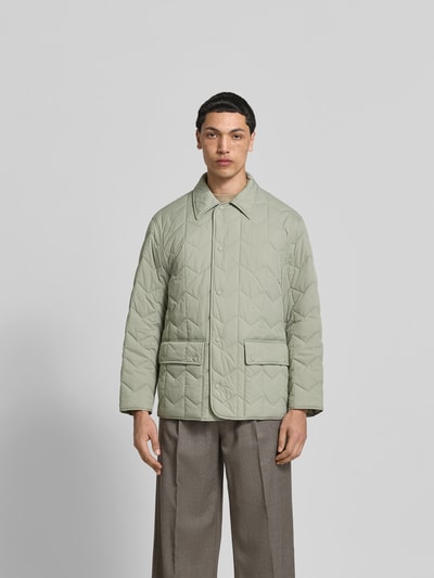 Männermodel trägt Regular Fit Jacke in Stepp-Optik von MAISON KITSUNÉ in Hellgrün mit Umlegekragen, Pattentaschen, Knopfleiste, Ganzkörperansicht von vorne. Rückenlänge 75 cm, Schulterbreite 48 cm, Ärmellänge 62 cm bei Größe M.
