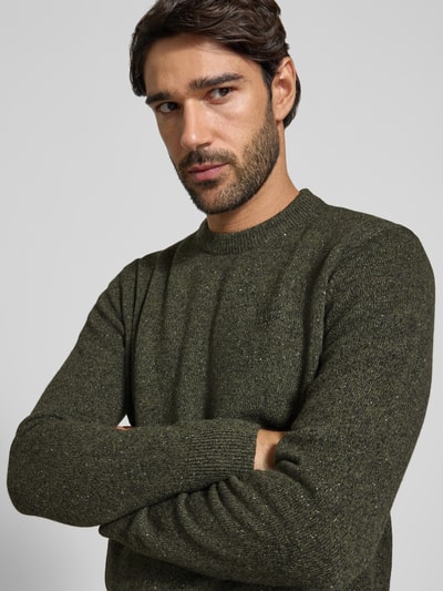 Männermodel trägt Pullover aus Woll-Seide-Mix mit Rundhalsausschnitt Modell 'TISBURY' von BARBOUR, unifarben, Strickoptik, Nahaufnahme Oberkörper.