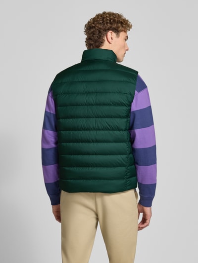 Männermodel trägt Regular Fit Weste mit Logo-Stitching von Polo Ralph Lauren in Dunkelgrün, glatte Oberflächen, Ganzkörperansicht Rückansicht.