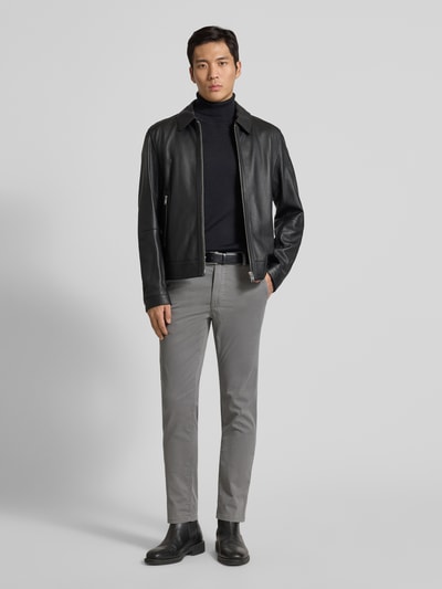 Męski model nosi Slim Fit Chino aus Baumwoll-Mix Modell 'CHINO_SLIM' od BOSS Orange, fakturowany wzór na całej powierzchni, szary kolor, szlufki na pasek, wpuszczane i tylne kieszenie, zapięcie na guzik i kryty zamek błyskawiczny, mieszanka bawełny, ganzkörperansicht z przodu.