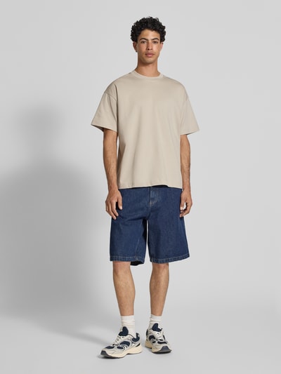 Männermodel trägt Herren T-Shirt mit Rundhalsausschnitt Modell 'BARRON' von Jack & Jones, Baumwoll-Mix mit Stretch-Anteil, Relaxed-Fit, Rückenlänge bei Größe M 73 cm, neutrale Farbe, glatte Textur, Ganzkörperansicht von vorne.